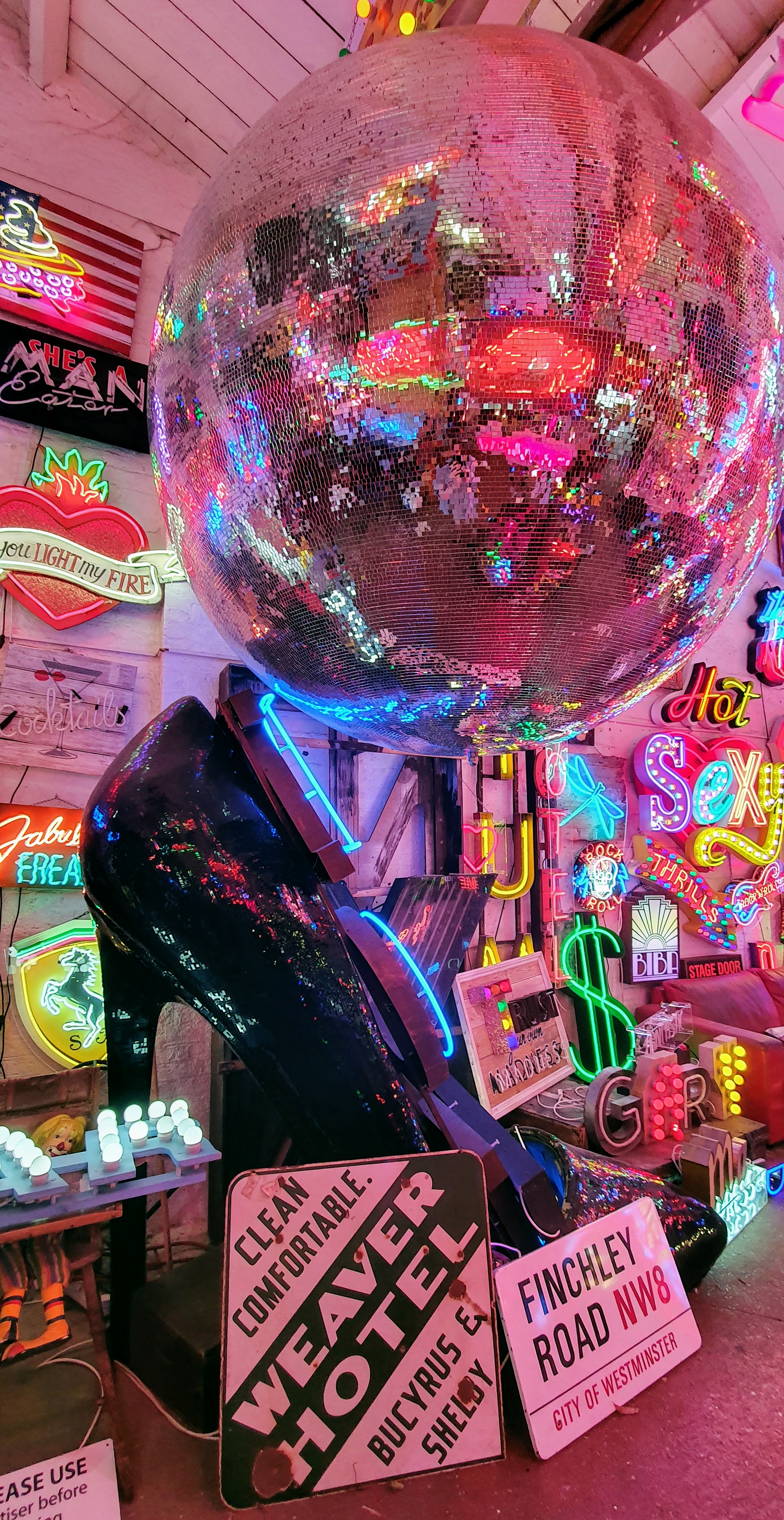 Glitter disco ball, neon lights and signs at God's Own Junkyard, Walthamstow, London