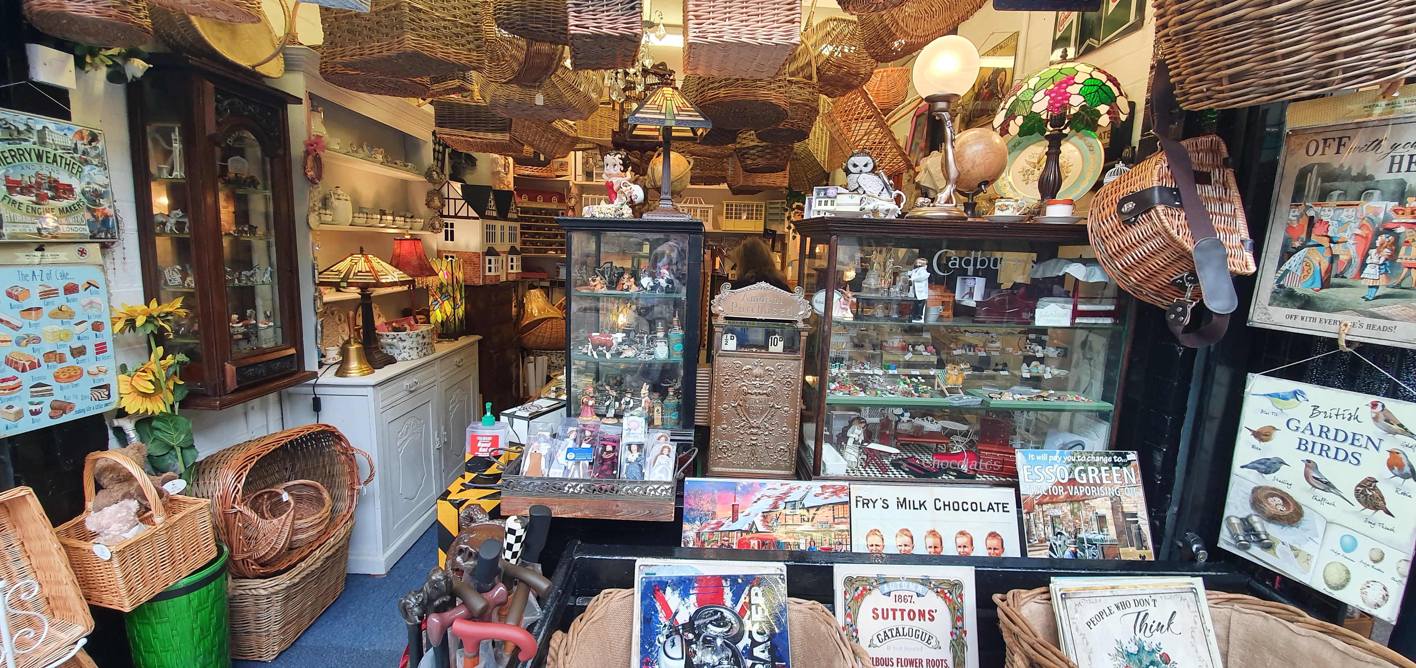 Antiques and wall signs at stall inside Butter Market, Leek, Stoke-on-Trent