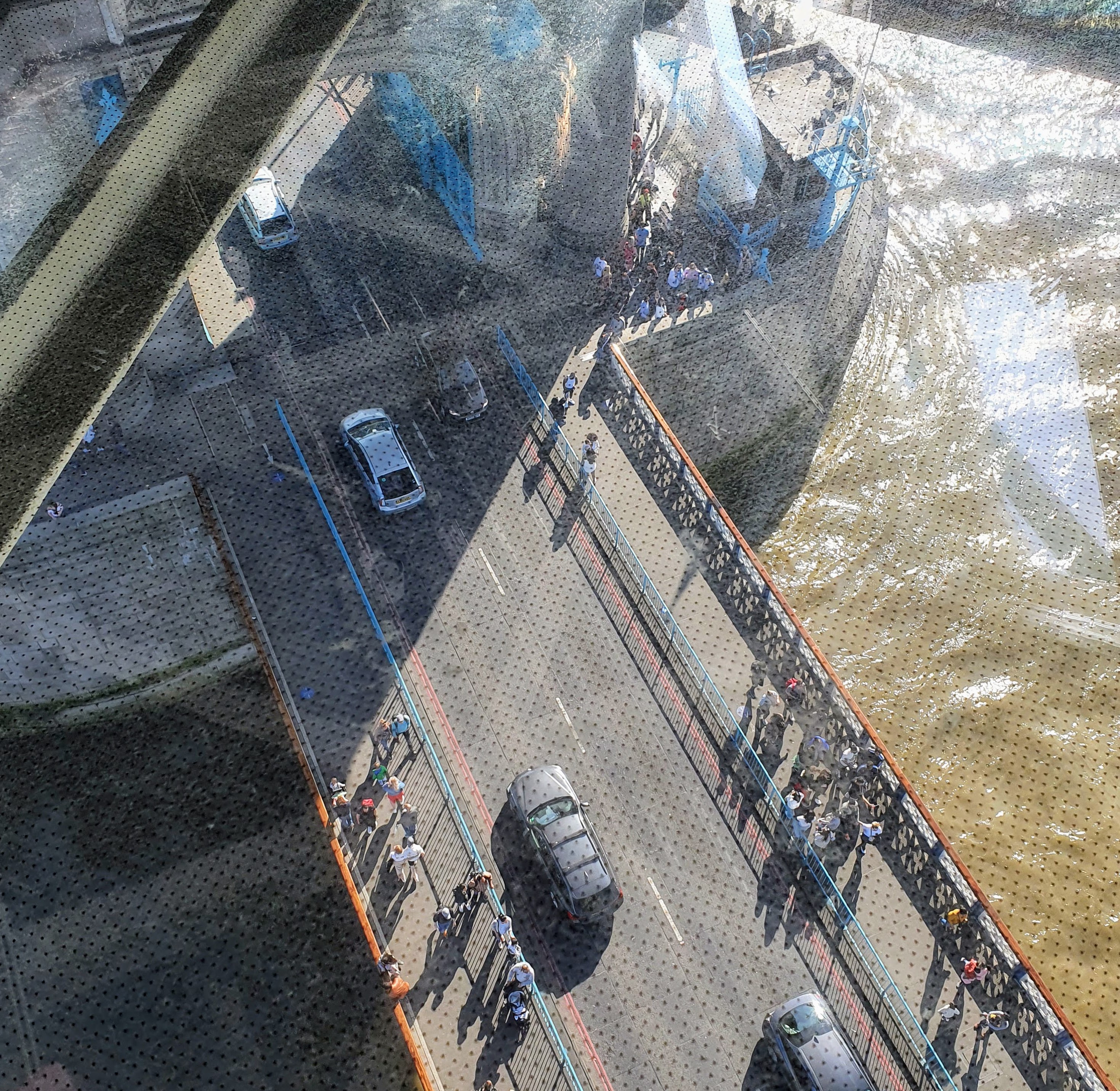 View of the River Thames and the road from the glass walkway of Tower Bridge, London